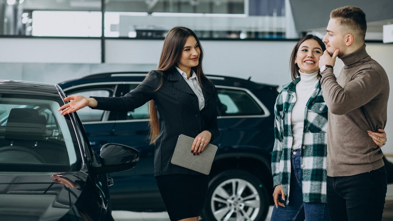 young-couple-choosing-car-car-show-room-min